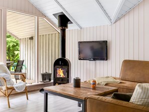 A cozy living area with a wood-burning stove, a flat-screen TV, and comfortable seating. - "Ejler" - 30km from the sea by Interhome (Toftlund)