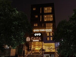 A multi-story building with illuminated signage for 'OYO TOWN HOUSE PUNJAGUTTA' and 'CASA The Grand Hotels'. - Townhouse Casa Grand (Hyderabad)