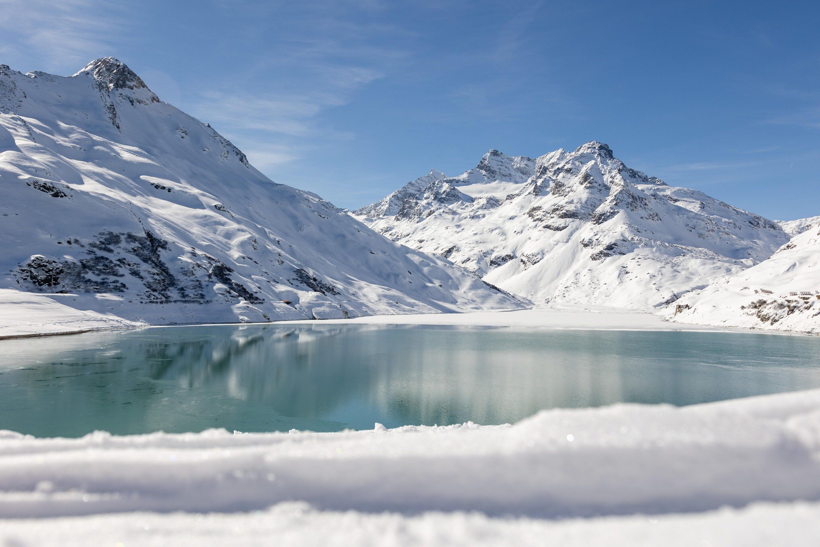 A snow-covered mountain landscape with a clear lake.