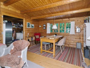 A log cabin interior with a dining area, kitchen, and a cozy living space. - 6 Person Holiday Home in Hundested (Hundested)