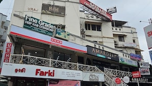 A multi-story building with various commercial establishments including a hotel, a spa, and a clinic. - Hotel Signature (Ahmedabad)