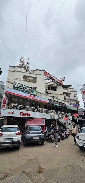A multi-story building with various commercial establishments including a hotel, a spa, and a clinic. - Hotel Signature (Ahmedabad)