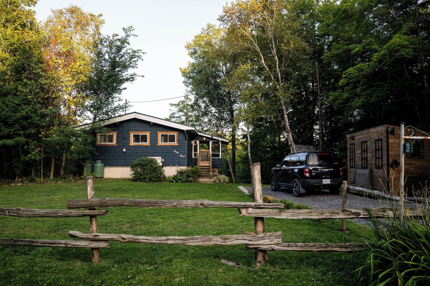 A house with a front porch, a garage, and a driveway.