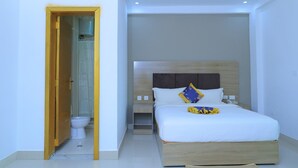 A modern bedroom with a wooden headboard, a white bedspread, and a nightstand with a phone. - Nile View Hotels - Quara  (Gondar)