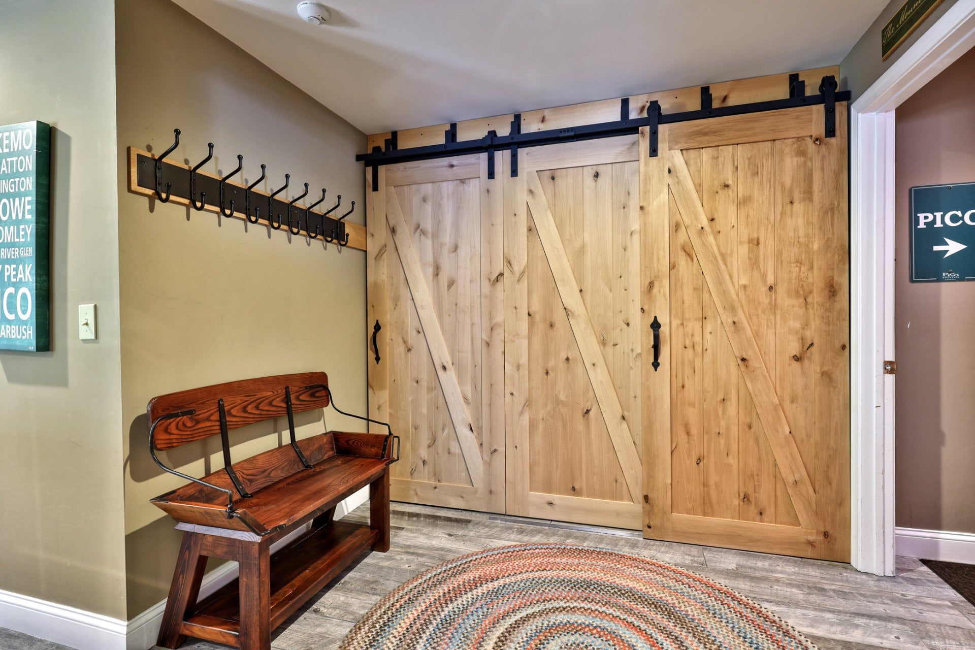 Take a seat to pull off your boots, then hang jackets on the row of hooks above.