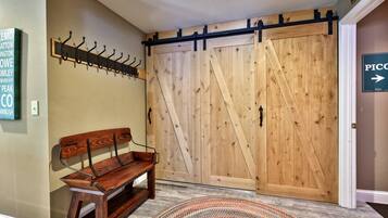 Take a seat to pull off your boots, then hang jackets on the row of hooks above.