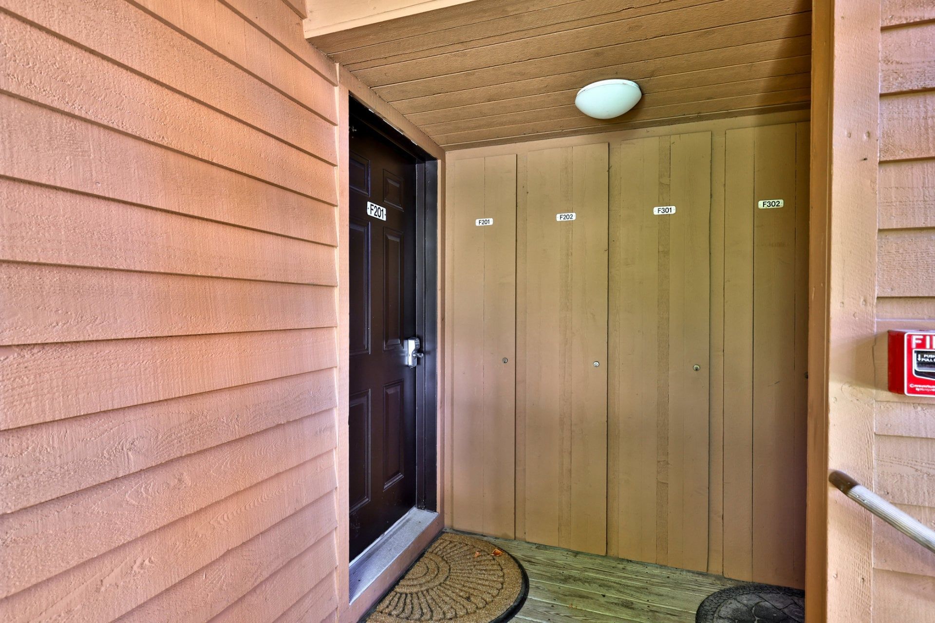 A hallway with a wooden door marked F201, F202, F301, and F302.