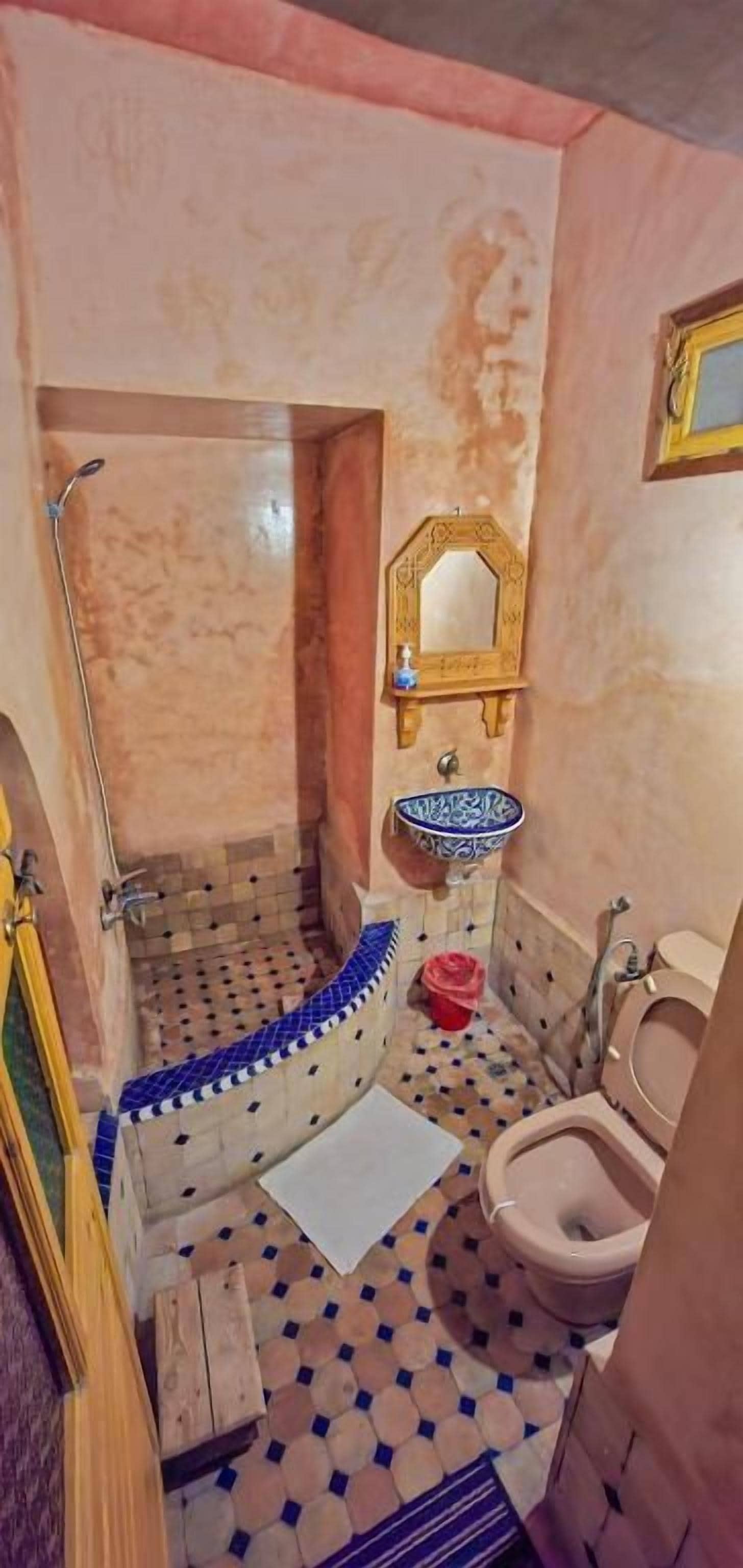 A bathroom with a bathtub, a sink, a mirror, and a toilet.