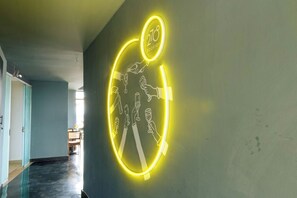 A hallway with a neon sign featuring a circular design and the text '270 Rooftop'. - Luxury 2-Bed Flat w/ Rooftop Pool & Gym (Nairobi)