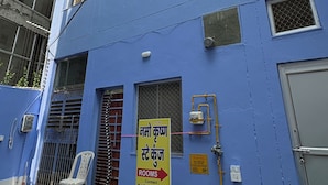 A multi-story building with a blue exterior, multiple windows, and a sign indicating rooms for rent. - Namo Krishn Stay Kunj (Mathura)