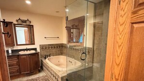 A bathroom with a glass-enclosed shower, a bathtub, and a vanity with a mirror. - Pet-Friendly 6BR Retreat on 14 Acres, Sleeps 12, Near Grand Rapids MN (Grand Rapids)