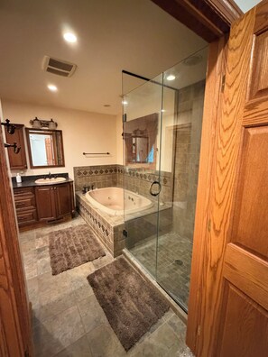 A bathroom with a glass-enclosed shower, a bathtub, and a vanity with a mirror. - Pet-Friendly 6BR Retreat on 14 Acres, Sleeps 12, Near Grand Rapids MN (Grand Rapids)