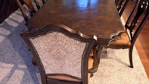 A dining room with a large wooden table, ornate chairs, a chandelier, and a view through a window with curtains. - Pet-Friendly 6BR Retreat on 14 Acres, Sleeps 12, Near Grand Rapids MN (Grand Rapids)