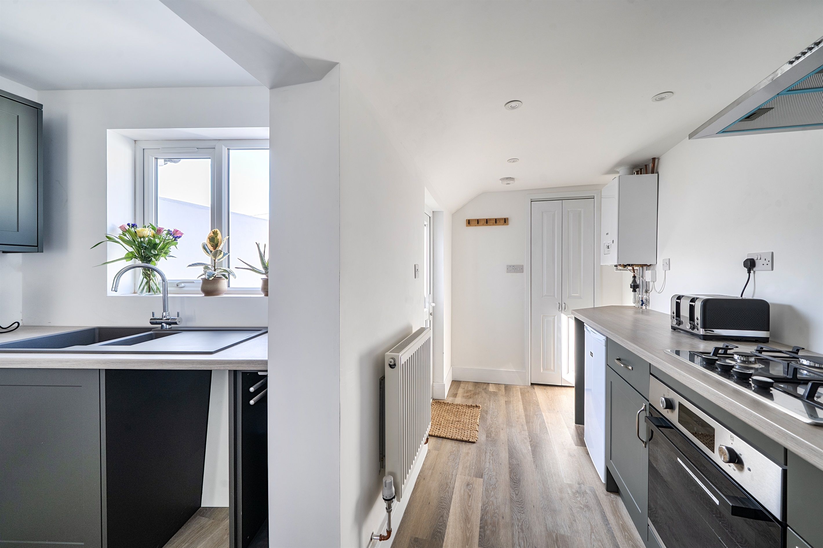 A modern kitchen with a built-in dishwasher, a microwave, and a stove.