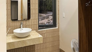 A bathroom with a large window, a sink with a mirror, and a wooden cabinet. - Anna Home Doc Let (Dong Ninh Hoa)