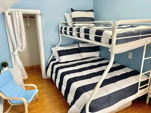 A bunk bed with striped bedding, a white chair, and a small plant. - Agate Bay Getaway - Short Walk to Lake Superior & Downtown (Two Harbors)