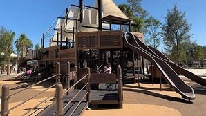 Ein Spielplatz mit Rutsche und Klettergeräten.