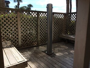 A wooden deck with a metal bollard, a wooden bench, and a lattice fence. - Direct Oceanfront: Million Dollar Sunrise Views & Steps to Coligny (Hilton Head Island)