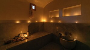 Ein schlecht beleuchtetes Badezimmer mit einer Badewanne, einem Waschbecken und einem Spiegel.