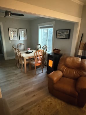 A dining area with a table and chairs, a fireplace, and a window. - Cozy Cascade retreat within walking distance of all that Cascade has to offer. (Cascade)