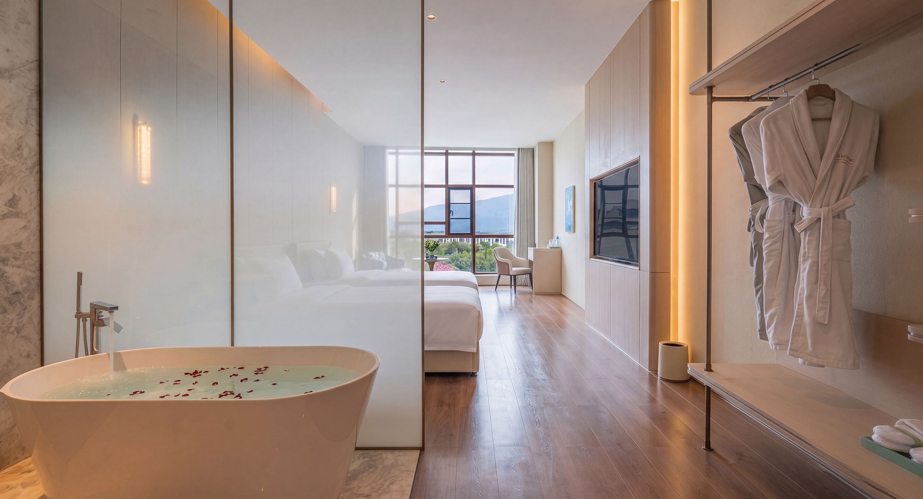A modern bathroom with a freestanding bathtub, a large mirror, and a robe rack.