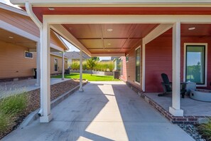A covered patio area with a concrete floor, outdoor seating, and a view of the backyard. - Hard Rock Hideaway @ Blue Whale/Route 66 (Catoosa)