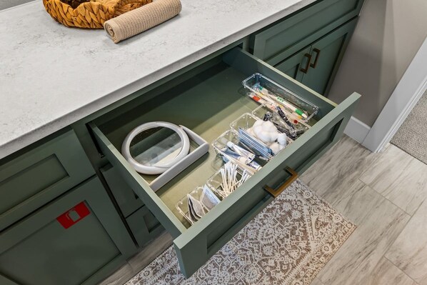 A kitchen with a drawer containing kitchen utensils and a white cable. - Hard Rock Hideaway @ Blue Whale/Route 66 (Catoosa)