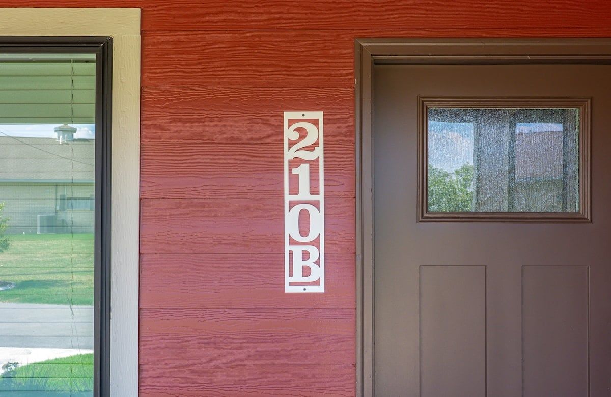A building entrance with a door and a window.