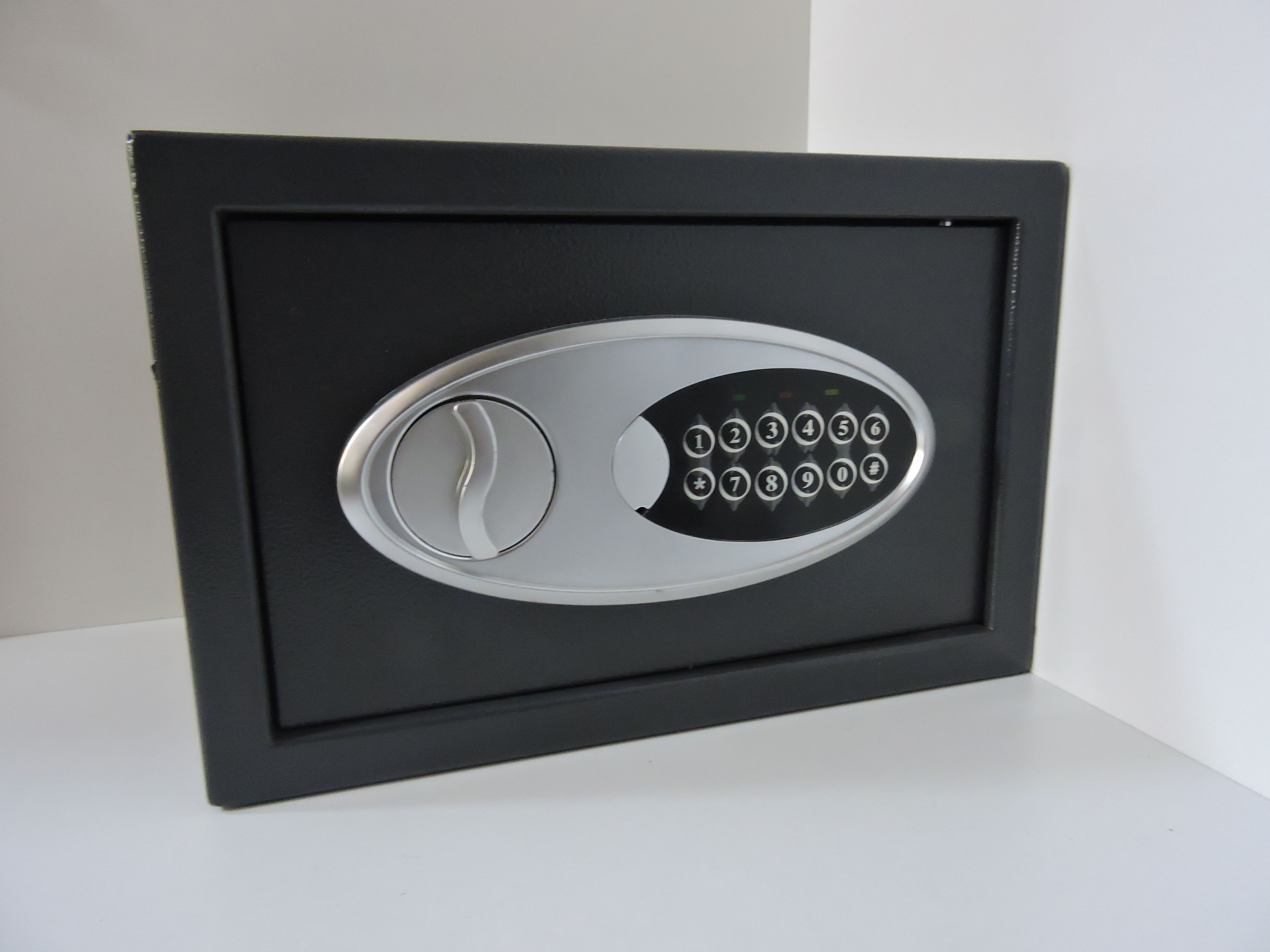 A black safe with a numeric keypad and a keyhole.