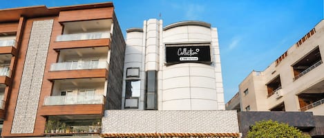 A building with a sign reading 'Collection' and 'OYO-Serviced'.
