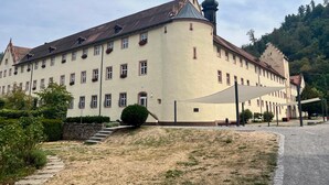 Un edificio grande e histórico con múltiples ventanas y una torre destacada.