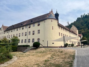 A large, historic building with multiple windows and a prominent tower. - Vrbo Property (Wolfach)