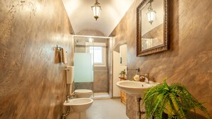 A bathroom with a toilet, bidet, sink, and a mirror. - In the Heart of Florence · 4 Min to Duomo & David (FIRENZE)
