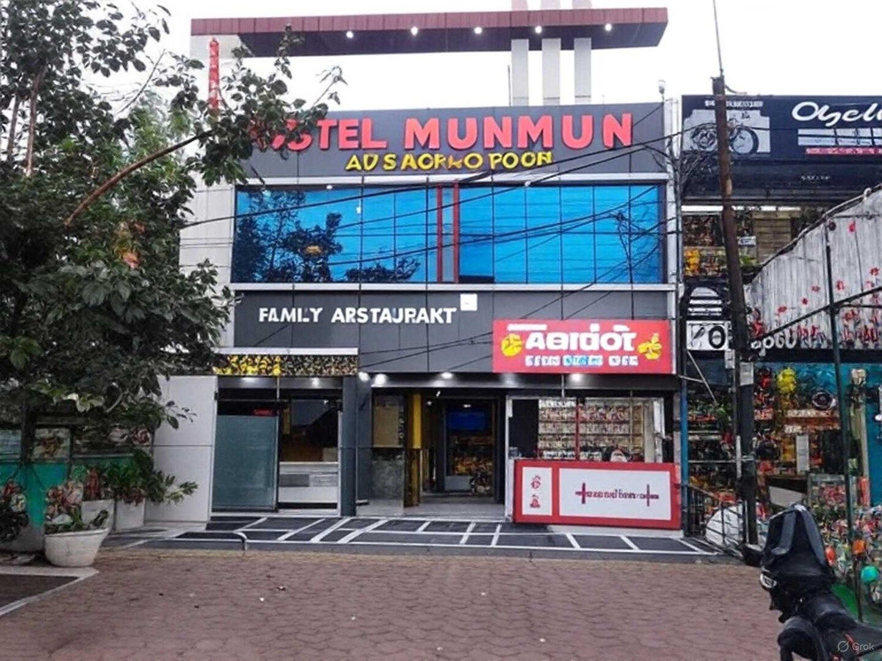 A hotel with a sign for 'Hotel Munmun' and a 'Family Restaurant' below it.