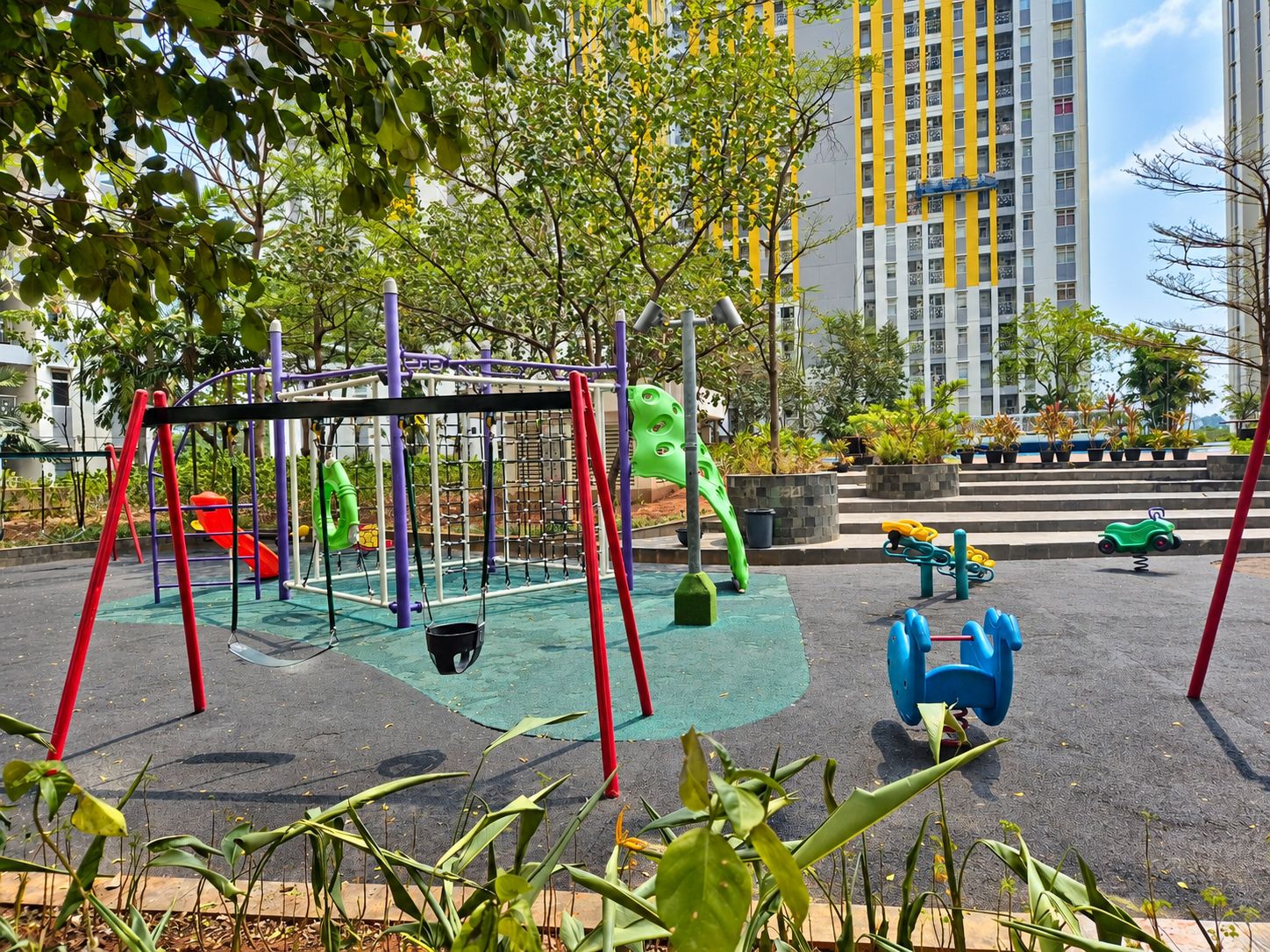 A playground with swings, slides, and climbing structures.