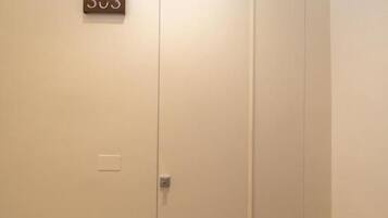 A closed door with a number plate indicating room 303.