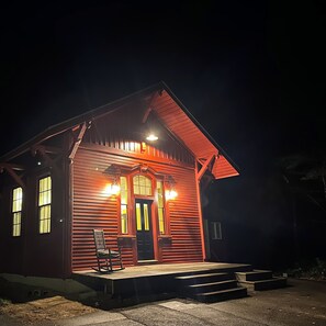 A wooden building with a porch, a door, and two windows. - Simpson Station: Historic Train Depot with direct access to recreational trails (Jay)