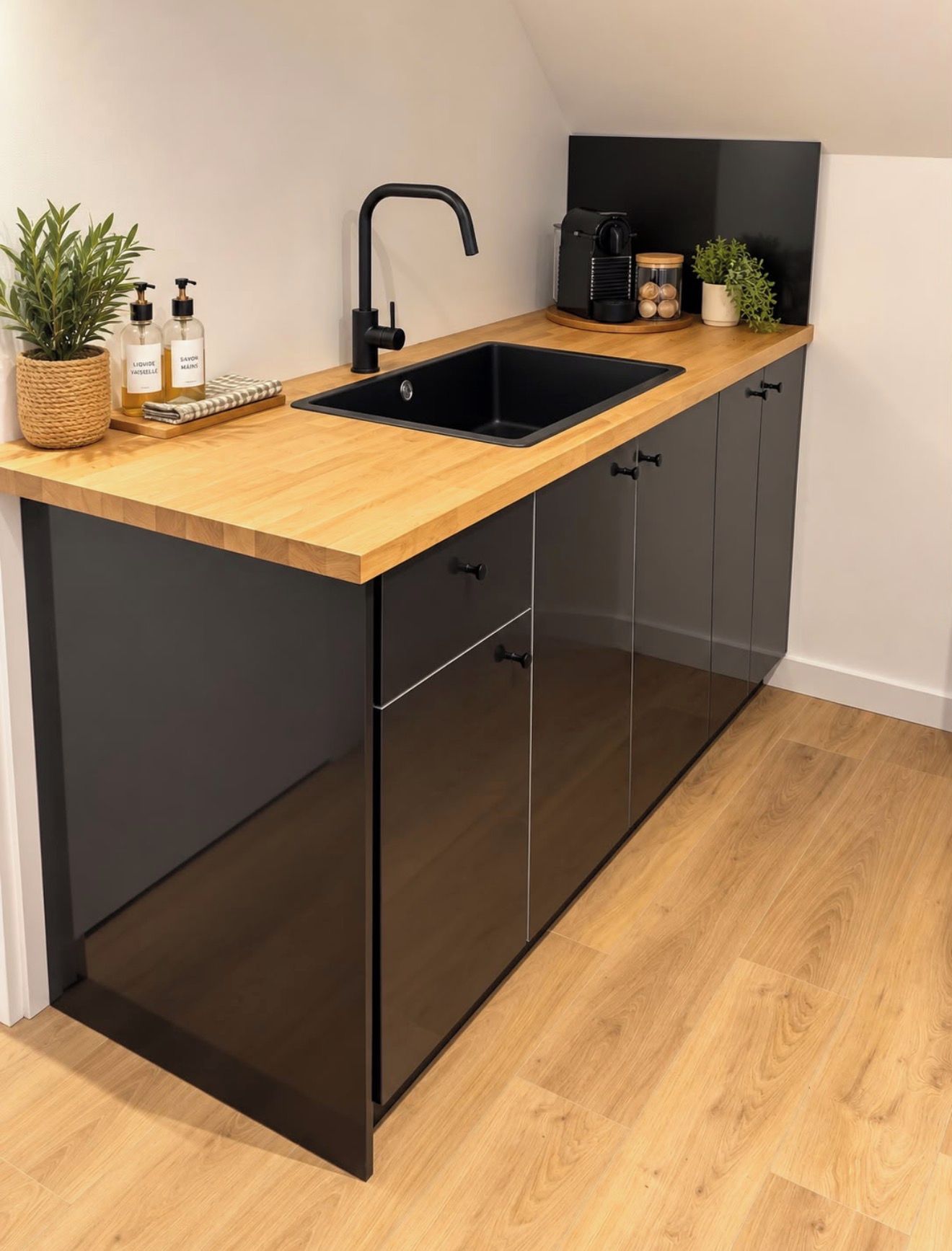 A modern kitchen with a wooden countertop, black cabinets, and a black sink.