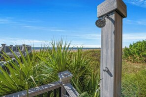 A wooden fence with a metal gate, leading to a beach with a clear sky. - Bahama Sands Luxury PH3- 3 Bedrooms Oceanfront (North Myrtle Beach)
