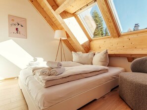 A cozy bedroom with a bed, pillows, a lamp, and a view through a skylight. - Chalet # Rfl006 for 2 People With Sauna (Oberwölz)