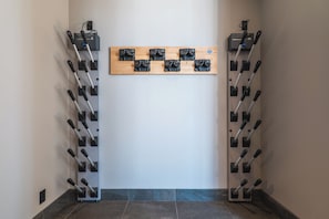 A hallway with a wall-mounted rack holding multiple dumbbells. - Yuki Drift (Kutchan-cho, Abuta-gun)