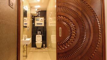 A modern bathroom with a toilet, sink, and shower.