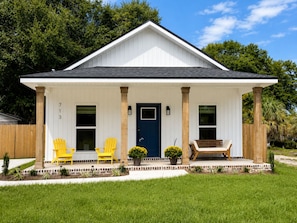 A single-story house with a front porch, a dark blue door, and a number '713' on the wall. - SunKissed on the Coast, well appointed, high-end home near DT. SMEG Espresso (Pensacola)