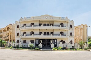 A multi-story building with a symmetrical facade, balconies, and a central entrance. - Luxury APT - 3BR - South Teseen (I) (New Cairo City)