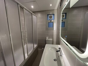 A modern bathroom with a glass-enclosed shower, a large mirror, and a white sink. - VESTA Luxury APT - 2Br - cfc (xc) (New Cairo City)