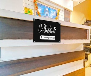 A reception desk with a sign that reads 'Collection' and 'Company Serviced.' - Suite Aysha Stay Inn (Kodaikanal)