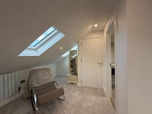 A bedroom with a skylight, a bed, a wardrobe, and a staircase leading to an upper level. - Boutique Stays - is a luxury hideaway in the Greenwich borough of London (Greater London)