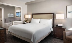 A hotel room with a large bed, bedside lamps, a nightstand, a dresser, a mirror, and a painting on the wall. -  Deluxe 2-bedroom condo ski in-out on slopes of Park City! Pool and hot tubs! (Park City)