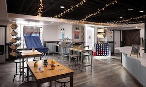 A cozy indoor space with tables, chairs, and string lights. -  Deluxe 2-bedroom condo ski in-out on slopes of Park City! Pool and hot tubs! (Park City)