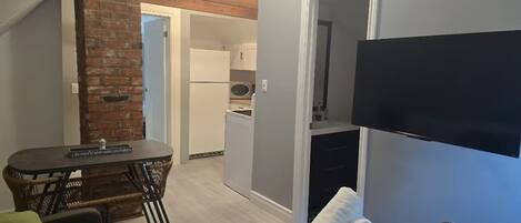 Living room: 50 inch mounted TV & a Luxury sofa for comfort - Converts into bed